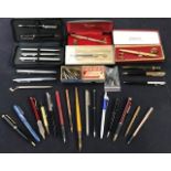 A collection of assorted pens including Parker