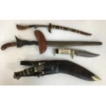 An Indonisian Kriss dagger; a kukri; other daggers; a British L6 Wombat 120mm recoiless anti tank