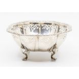 A Continental 900 standard shaped floral bowl, with cast wavy rim above reticulated border, on