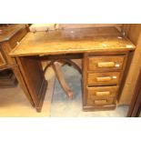 An early 20th Century oak desk, fitted with four drawers