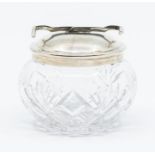 A George VI cut glass novelty sugar jar and silver cover with intregal pincers, the pincers