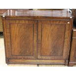 An early to mid 19th Century mahogany two door cupboard, altered, raised on a plinth base, 97cm