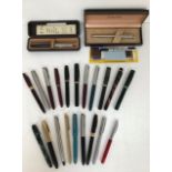 A collection of fountain pens, some with 14ct gold nibs