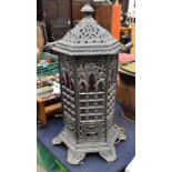 A floor standing cast iron heater converted to a lamp, glass panels fitted to the inside. Height