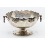A George VI silver large shaped circular bowl, wavy rim applied with scrolling leaf motifs, plain