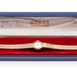 An Audax ladies 9ct gold watch, round champagne dial, 11mm, baton and number markers, fancy integral
