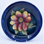 Moorcroft: A Walter Moorcroft 'Dahlia' pattern plate. Diameter 19cm. Marks to the base. Condition: