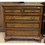 A George III oak and mahogany cross-banded chest of drawers, circa 1790, comprising two short over