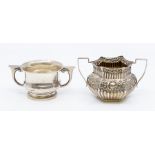An Edwardian silver sugar bowl, chased with gadroon sections and central scrolling foliage,