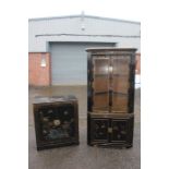 A Chinese black lacquered corner display cabinet, fitted with two glazed doors and two panelled