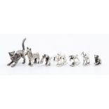 A collection of seven small silver cast animals including a stag, a wolf, cats and dogs, the sallest