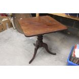 An early Victorian mahogany rectangular tilt top supper table, central tripod support, raised on