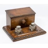 A 1930's oak desk writing box with original ink wells