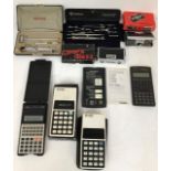 A collectors lot to include vintage calculators from the 1980's, opera glasses, draughtman's sets in