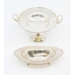 A George V silver raised two handled bon bon dish, twin loop handles on raised base, by Goldsmiths &
