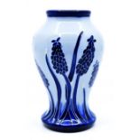 Moorcroft Pottery: A Moorcroft Florian 'Grape Hyacinth' pattern vase. Height approx 10cm.