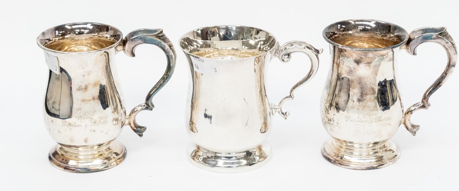 An Elizabeth II plain silver mug, with scroll handle acanthus thumbpiece, engraved with monogram, by