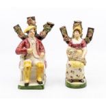 A pair of Staffordshire pearl ware figures of an old man and a lady holding a sheep ***