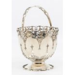 A George V silver circular swing handled basket, wavy rim above openwork foliate section, wavy mid