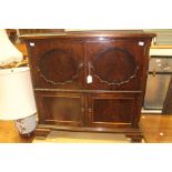 An early 20th Century mahogany drinks cabinet, two doors over two doors, ogee bracket feet, 77cm