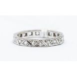 A mid century 9ct white gold eternity ring set with white stone possibly white quartz, each stone
