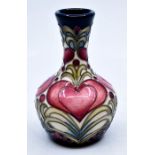 Moorcroft Pottery: A Moorcroft stylised floral heart pattern vase. Height approx 10cm. Impressed