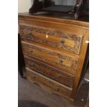 Two late 20th Century hardwood chests of drawers, carved drawer fronts, each fitted with four long