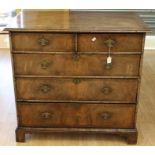 A George I style walnut chest of drawers, comprising two short over three long drawers, feather