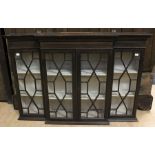 An early 20th Century mahogany breakfront glazed wall cabinet, in the Chippendale style, fitted with