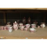A collection of red and white teawares, comprising coffee pots, soup dishes, plates, teapot,