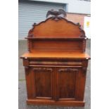 A Victorian mahogany chiffonier, circa 1850, the top with a carved eagle surmounted, shaped back,