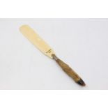 A Victorian ivory page turner, silver mount with deer foot terminal, the ivory inscribed: Deskrie