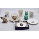 A Royal Worcester pin dish painted with bird on branch; three Goss beakers; a Sylvac dog and