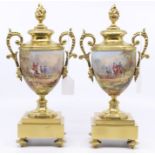 A pair of gilt brass hand painted urn garnitures, with 18th Century scenes