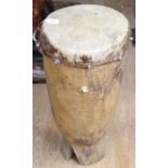 An African Tribal floor standing drum, with skin covering over an adze wooden base, early to mid