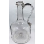 A George I magnum glass decanter jug with string rim and high kick to base, circa 1720  Note: This