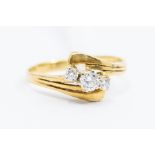 A diamond and 18ct gold three stone ring, comprising three claw set round brilliant cut diamonds,