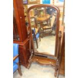 A Victorian mahogany cheval mirror, floor standing and on castors