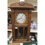 A 1930's oak wall clock, along with early 20th Century oak wall barometer (2)