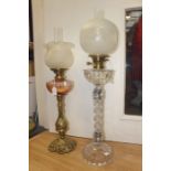 Two early 20th Century glass and brass oil lamps with etched shades and funnels