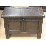 A late 17th Century joined oak chest, carved frieze to front, having a two panel lid, retaining wire