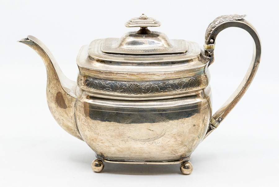 A George III Provincial large silver teapot oblong shaped with bright cut engraved decoration, the