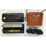 Small 1930's Baby Bee typewriter along with a pair of binoculars in case