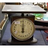 A Bakelite Smiths of Enfield electric wall clock along with Post Office scales, Salter No 52 metal