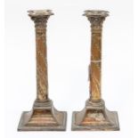 A pair of late 19th Century Neo-Classical style plated candlesticks, Corinthian columns above