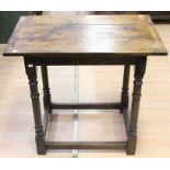 A 17th Century style joined oak side table, the three plank top with cleated ends, raised on