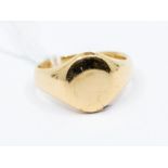 An 18ct gold signet ring, unmarked assessed as 18ct gold, oval cartouche, width of head 13mm, size
