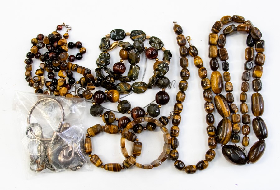 A collection of jewellery to include tigers eye bead necklaces along with two bracelets and a tigers