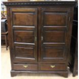 A mid to late 18th Century joined oak two door cupboard, each door with three raised and fielded