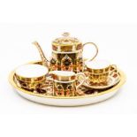 A Royal Crown Derby Imari palette 1128 pattern miniature cabaret set on tray, comprising teapot,